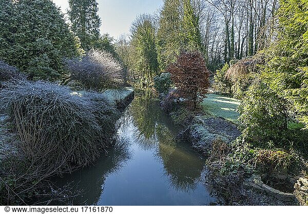 A small stream flowing though gardens at Cove in the Exe Valley in Winter  Devon  England.
