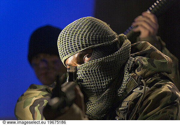 A soldier pointing a gun.