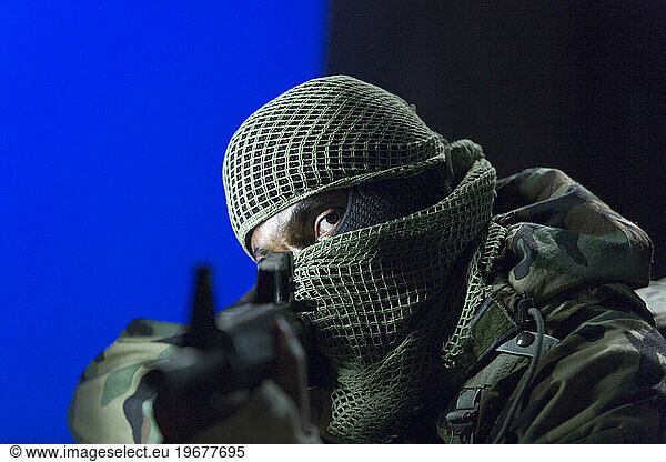 A soldier pointing a gun.