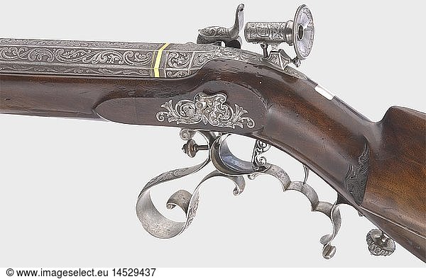 A splendid percussion target rifle  J. KÃ¤stli at Paris  circa 1840. Heavy octagonal barrel with a bright  seven-groove rifled bore in 10 mm calibre. The signature  'J. KÃ¤stli a Paris' is inlaid in gold on top of the barrel  and there is richly engraved rocaille and vine ornamentation on the breech and near the muzzle. Finely engraved and cut tang with a dismountable engraved micrometer aperture sight. Lavishly cut and engraved percussion lock with an additional signature. Vent with platinum bushing. Double set trigger. Lightly carved stock of beautifully figured walnut with a vacant silver escutcheon. Iron furniture richly covered with engraving  the bottom of the forearm is lightly pitted. Trigger guard bears the engraved monogram 'WB'. Inserted ramrod with brass tip. Length 128 cm. Johannes Kaspar KÃ¤stli (1814 - 1890) was active in St. Gallen and Paris. Cf. StÃ¶ckel  p. 608. historic  historical  19th century  civil long guns  gun  weapons  arms  weapon  arm  firearm  fire arm  gun  fire arms  firearms  guns  object  objects  stills  clipping  clippings  cut out  cut-out  cut-outs