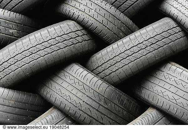 A stack of discarded old rubber automobile tires.
