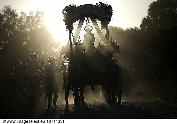 A statue of Saint Isidore the Farmer  is carried in a carriage along a dusty road during a pilgrimage in Prado del Rey village  Cadiz Province  Andalusia  Spain  May 16  2010.