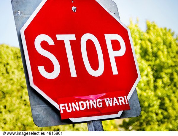A stop sign turned into a protest sign against the funding of war