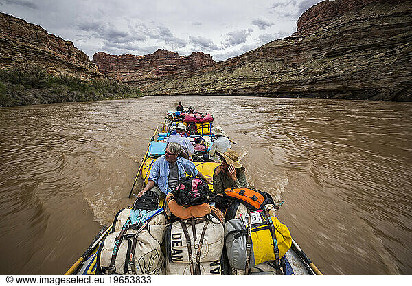 A string of rafts floating down a river.