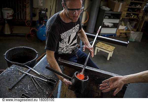 A student receives instruction during a glassblowing lesson at the Berlin Glas workshop in Wedding  Berlin  Germany.
