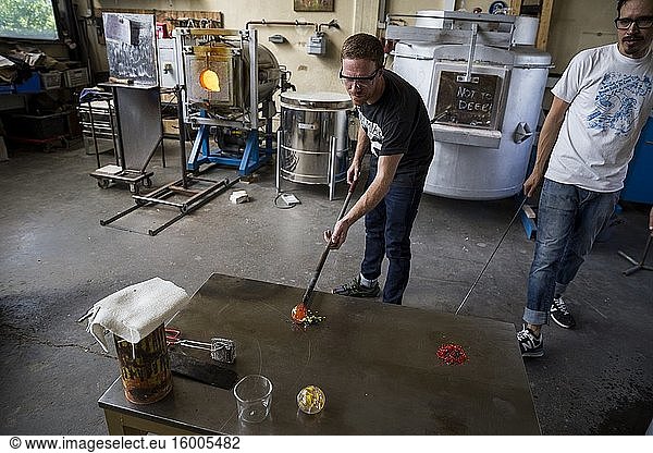 A student receives instruction during a glassblowing lesson at the Berlin Glas workshop in Wedding  Berlin  Germany.