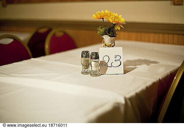 A table with flowers and table number 23 sits vacant at a restaurant in Seattle  Washington.