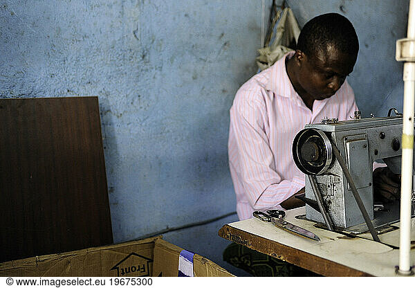 A tailor sews a garment in Bamako