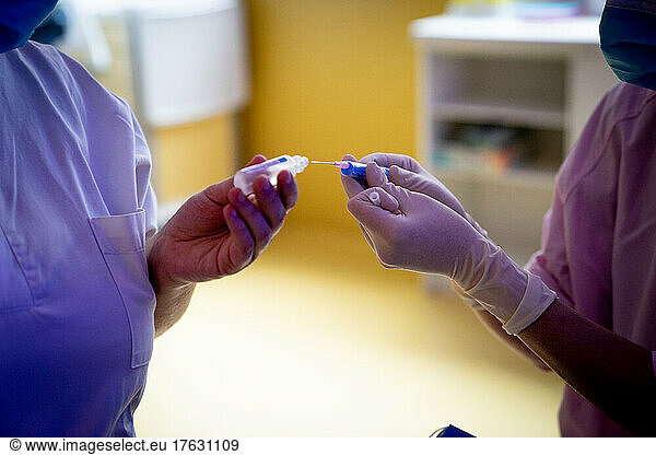 A team prepares a feeding tube for a premature baby.