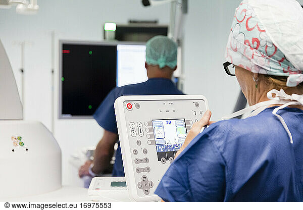 a technician operates a medical imaging device in the operating room