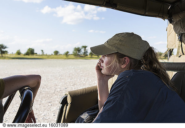 A teenage girl in a safari vehicle
