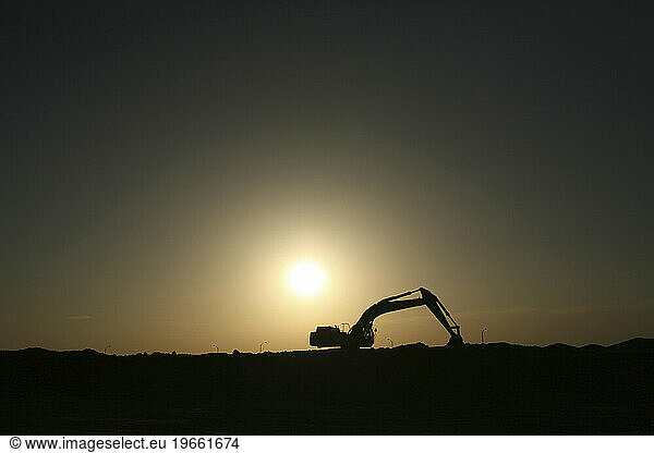 A tractor sits vacated as the sun sets in northern California  2006.