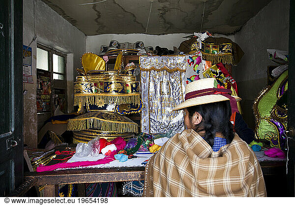 A traditionally dressed woman in a shop in Oruro  Bolivia.