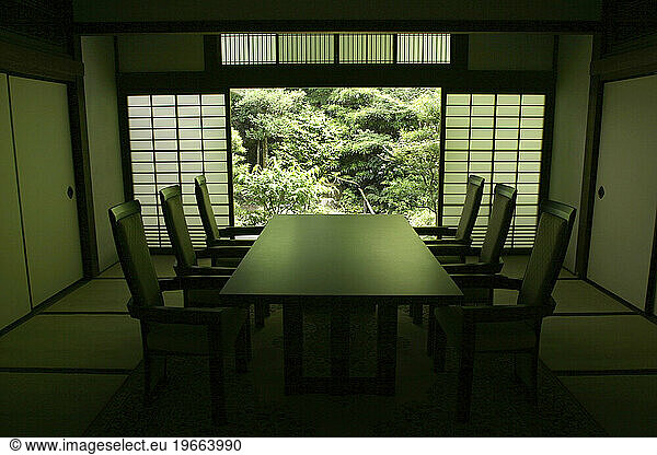 A traditionally styled Japanese table with a garden outside. Kyoto  Japan.