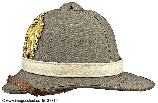 A tropical helmet M 1900 of the East Asiatic Expeditionary Corps Depot piece. Cork body with field-grey textile covering and edging (blemishes)  unscrewable ventilation cap and folding neck guard. Green liner  brown leather sweatband with size stamping '54 1/2'  embossed maker's crest and lettering 'Ludwig Bortfeldt Bremen'  brown chinstrap with brass slides. The neck guard underside stamped 'B.A.O. 1903' and quadruple stamped '10 IR - I.B. - 3.K. - 1905'. Pinned on golden imperial eagle  trim band in white arm of service colour with pinned lacquered Reich cockade. A very rare helmet of military historical importance  as it introduced the functionality of field-grey clothing in place of the colourful but impractical traditional colouration. historic  historical  navy  naval forces  military  militaria  branch of service  branches of service  armed forces  armed service  object  objects  stills  clipping  clippings  cut out  cut-out  cut-outs  20th century