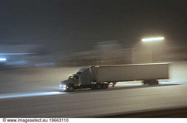 A truck speeds on a snow covered highway at night in Ashland  Oregon.