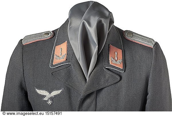 A tunic for a flight engineer Private purchase piece in Luftwaffe-blue cloth with covered fly (two buttons missing)  curved waist pockets without flaps and a blue silk liner. Silver collar cording  silver embroidered breast eagle  pink collar tabs with silver embroidered propellers  sewn-in shoulder boards with pink underlay. A rare service branch colour. historic  historical  Air Force  branch of service  branches of service  armed service  armed services  military  militaria  air forces  object  objects  stills  clipping  clippings  cut out  cut-out  cut-outs  20th century