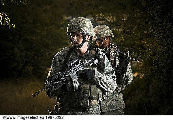 A two-man Air Force Security Forces team patrol the compound perimeter during combat operations training.