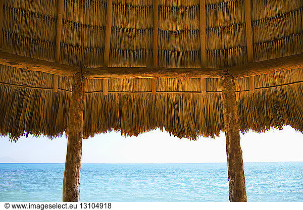 A typical thatched roof cabana on an ocean beach in the Caribbean