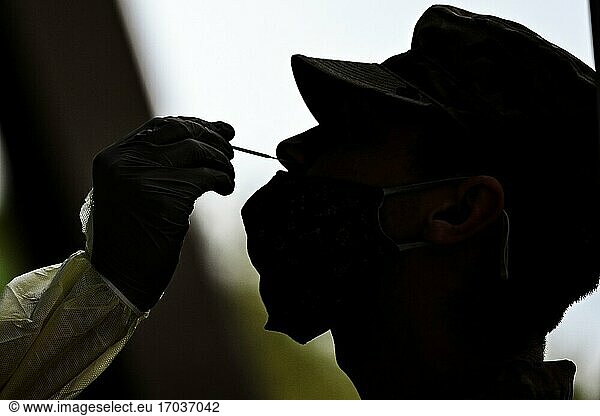 A U. S. Air Force Airman receives a nasal swab during pre-deployment COVID testing at Joint Base Langley-Eustis  Virginia  Oct. 17  2020. A contingent of 94th Fighter Squadron Airmen and F-22 Raptors assigned to the 1st Fighter Wing  deployed to Andersen Air Force Base  Guam  to conduct missions in the Western Pacific with allies and joint partners. (U. S. Air Force photo by Staff Sgt. Ericha Fitzgerald).