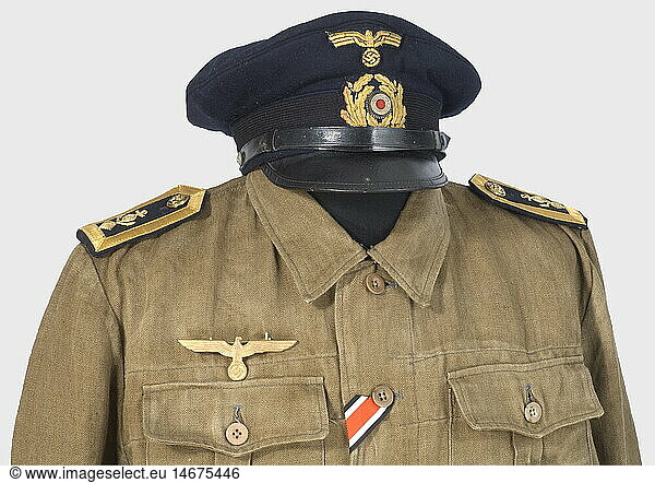A uniform ensemble for a machinist's mate petty officer.  A service cap of fine  navy blue cloth with black mohair cap band  gold-embroidered insignia (cello)  black lacquered visor and chin straps  blue silk lining (label missing) and leather sweatband. Sand-coloured linen blouse from a U-boat working uniform  with brown horn and golden anchor buttons  shoulder boards on loops  and Iron Cross buttonhole ribbon. Attached metal chest eagle and U-Boat War Badge (fine zinc  migrated). Ensemble includes matching trousers of the same material. Olive brown pullover. Brown canvas shoes with black leather trim. historic  historical  1930s  1930s  20th century  navy  naval forces  military  militaria  branch of service  branches of service  armed forces  armed service  object  objects  stills  clipping  clippings  cut out  cut-out  cut-outs