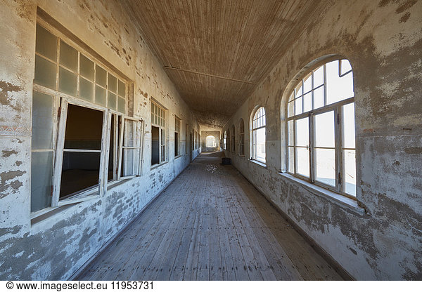 A view of a corridor in a derelict building.