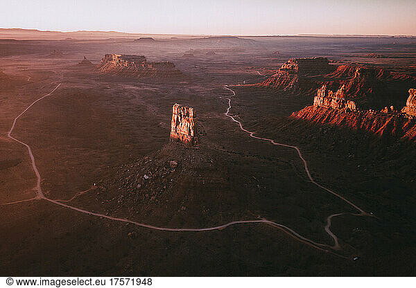 A view of famous rock formations and a road in Valley of the Gods