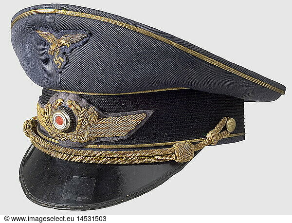 A visor cap for generals.  Luftwaffe blue gabardine with a black mohair cap band  golden piping  golden cap cord  and gold-embroidered insignia. Golden yellow ribbed silk lining  stamped 'Luxus' in silver under the transparent label in the centre of the top lining. Ersatz material sweatband (loose in places). historic  historical  1930s  1930s  20th century  Air Force  branch of service  branches of service  armed service  armed services  military  militaria  air forces  object  objects  stills  clipping  clippings  cut out  cut-out  cut-outs  uniform  uniforms  clothes  piece of clothing  headpiece  headpieces  cap  caps  hat  hats  bonnet  bonnets  accessory  accessories