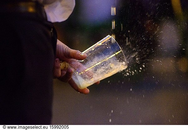 A waiter pours cider into a glass in the Requexo neighborhood  Mieres  Asturias  Spain