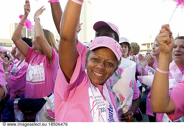 A walker celebrates during the closing ceremonies of the Avon Walk for Breast Cancer in New York City.
