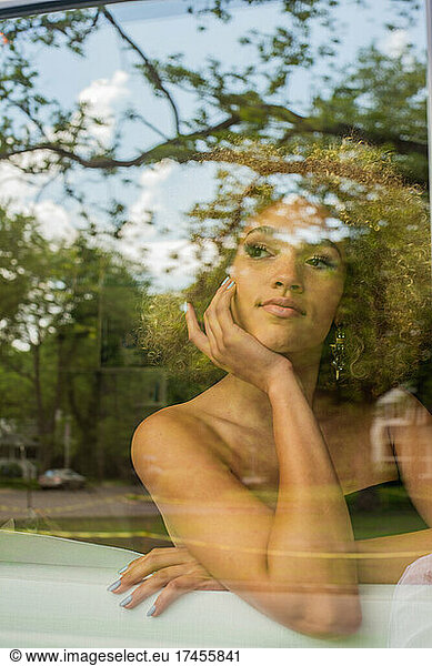 A window portrait of a beautiful girl