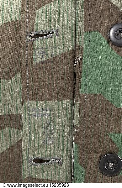A winter camouflage suit in splinter pattern camouflage non-reversible issue Lined  the exterior with splinter pattern camouflage  the bluish silk liner with dark plastic buttons. Covered fly and additional cover strip (the underside stamped 'GrÃ¶ÃŸe II' and '12') as wind protection  two hip pockets with closure flaps  inside woven securing belt at the waist and sleeve ends  the hood with exterior camouflage pattern. The trousers in the same style  raised back for wear with suspenders  straight covered fly with additional cover strip as wind protection  two hip pockets with closure flaps  slit leg terminals with securing straps. Light linen suspenders with reinforcement of camouflage material. Mint  unused  either piece with a paper tailor's label. historic  historical  Air Force  branch of service  branches of service  armed service  armed services  military  militaria  air forces  object  objects  stills  clipping  clippings  cut out  cut-out  cut-outs  20th century