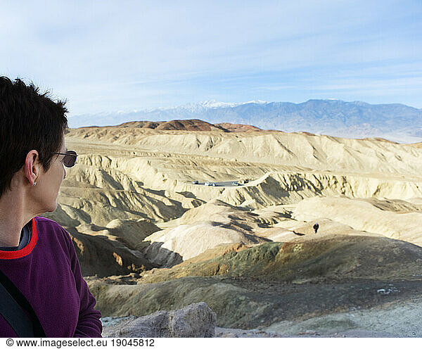 A woman admiring the view of the desert from the the Artist's Palette. Death Valley National Park  California.