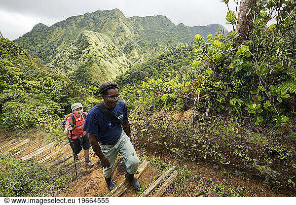 A woman and her guide hike the trail to Boiling Lake in the Morne Trois Pitons National Park on the Caribbean island of Dominica.