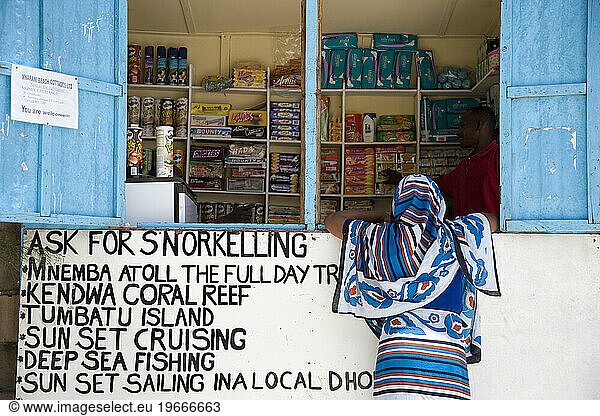 A woman buying from a local store Nungwi village
