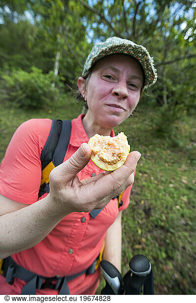 A woman enjoys a fresh guava picked from a tree in the French Quarter on Segment 1 of the Waitukubuli National Trail on the Caribbean island of Dominica.