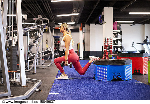 A woman exercising in the gym.