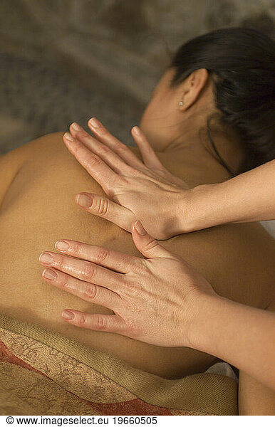 A woman getting a massage at a spa.