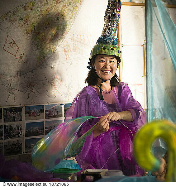 A woman getting ready for a parade in Santa Barbara. The parade features extravagant floats and costumes.