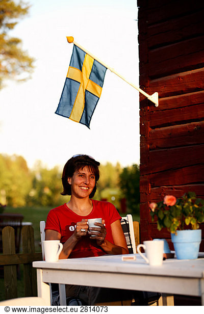 A woman having a cup of coffee Norrbotten Sweden.