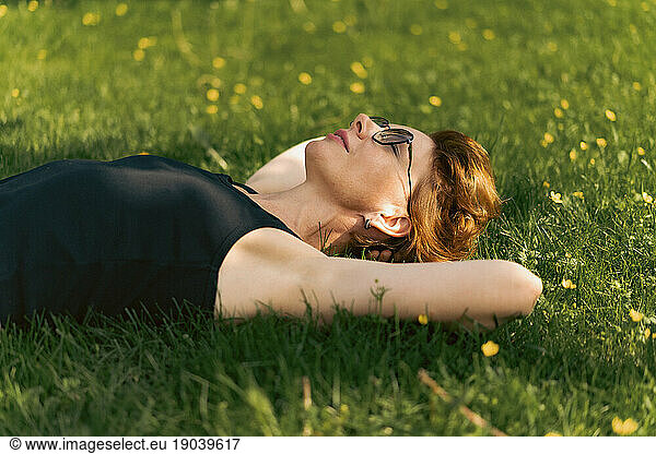 A woman lies on the grass  summer atmosphere.