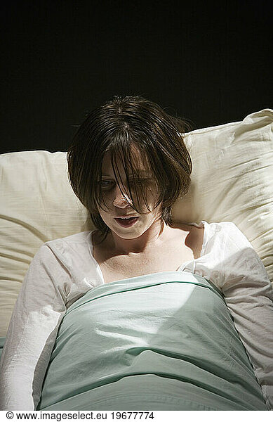 A woman lying in a hospital bed.