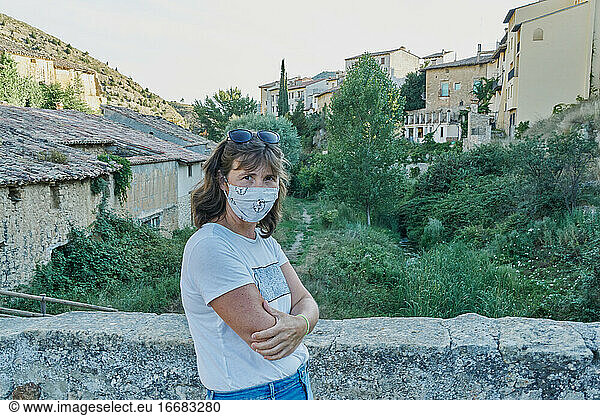A woman protects herself from the coronavirus with a mask in a s