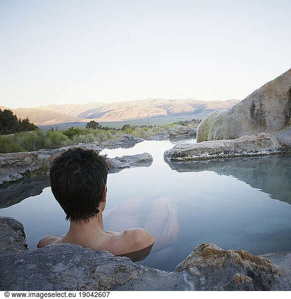 A woman sits alone in Travertine Hot Spring  Bridgeport  California.