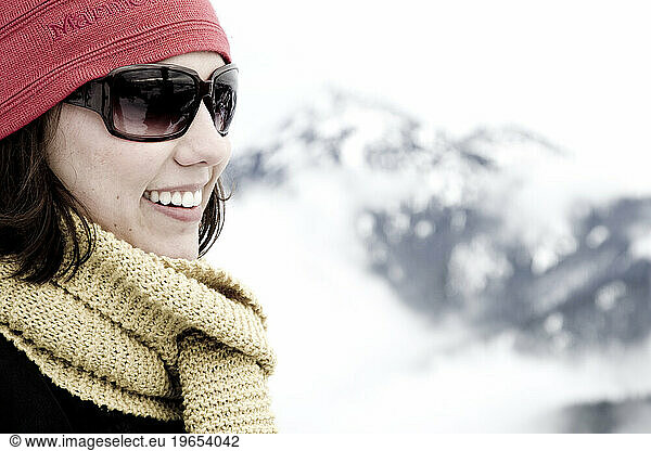 A woman smiling while in the mountains.