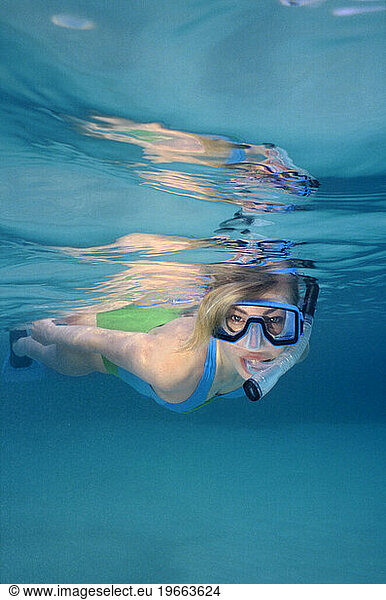 A woman snorkeling in the Bahamas.