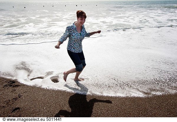 A woman splashes about in the Pacfic Ocean at Rodeo Cove near San Francsico  CA
