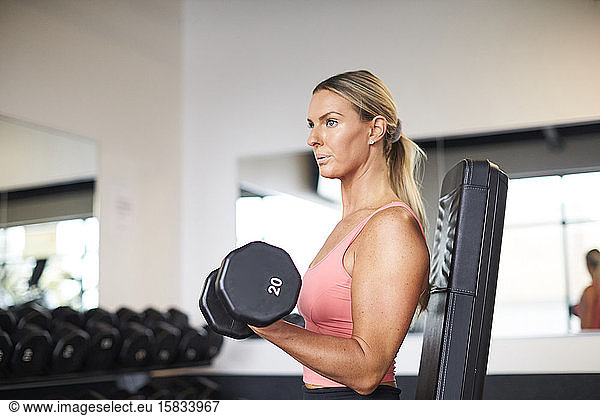 A woman strength training in the gym.