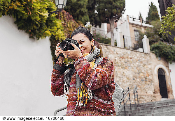 A woman tourist with a camera on the streets of Granda  Portugal