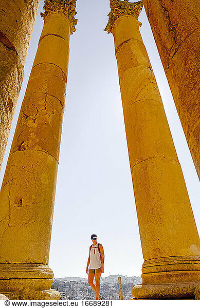 A woman walks among ruined Roman columns in Jerash  Jordan